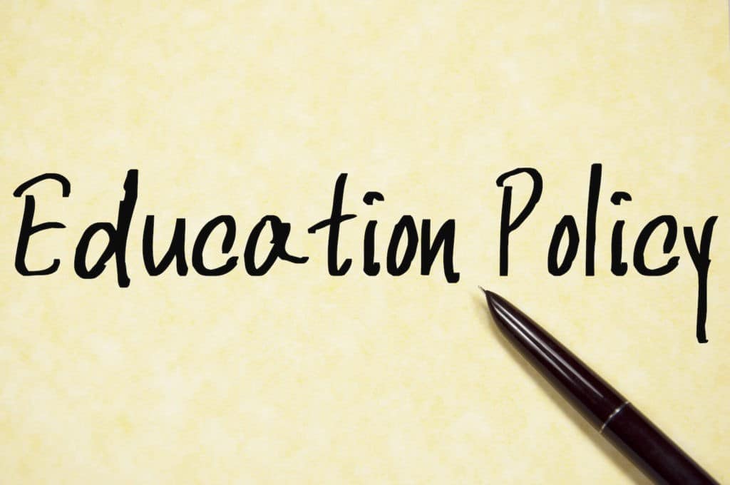 ‘Education Policy’ written on paper next to a pen.