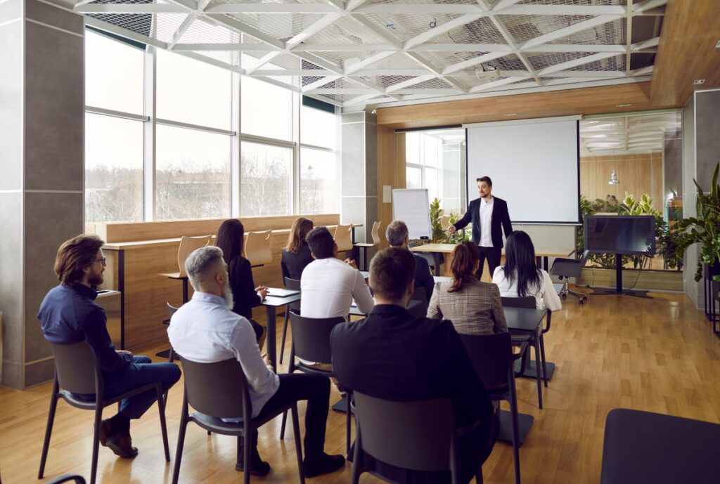 A group of employees participate in staff training in the office.