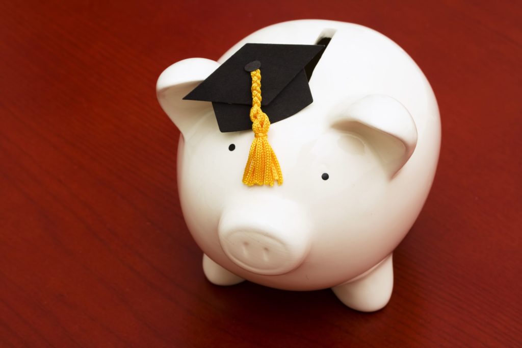 Piggy bank wearing a graduation cap.
