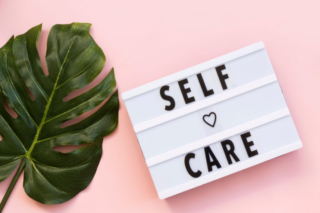 “Self-care” spelled out and displayed on a lightbox.