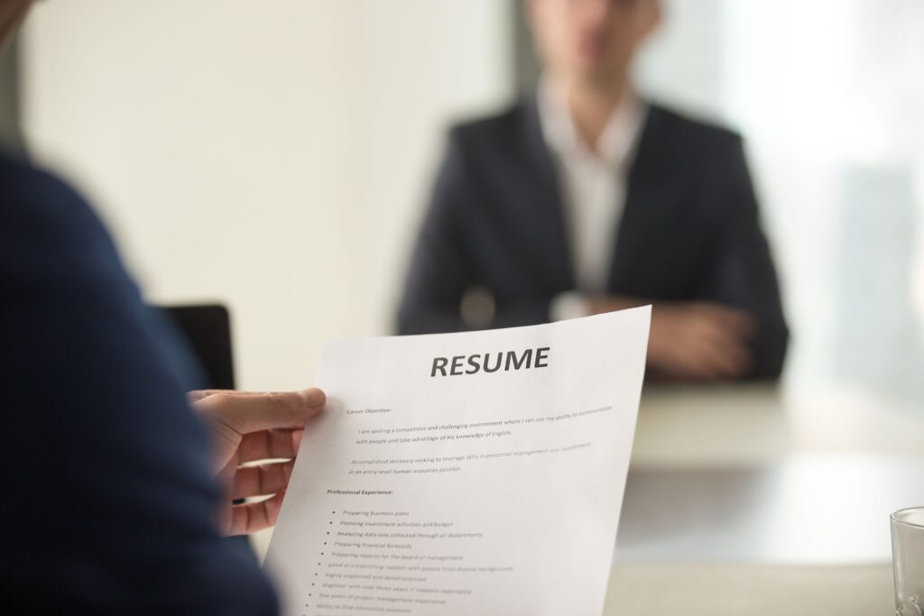 Close-up of an employer holding a job applicants resume.