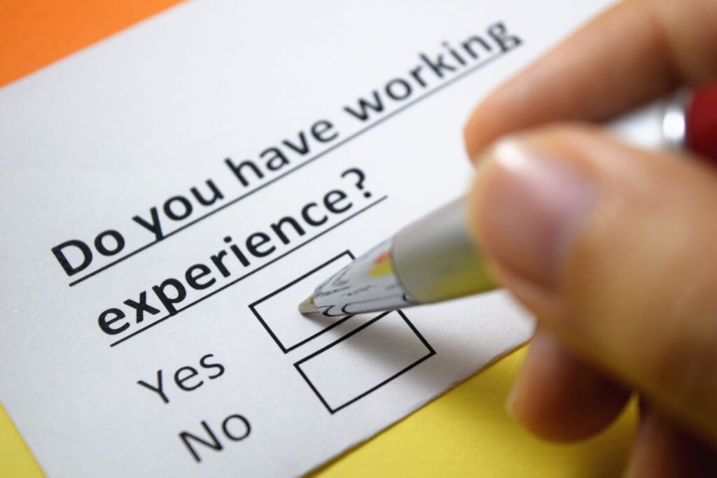 A close-up of someone checking a box on a form asking whether they have work experience.