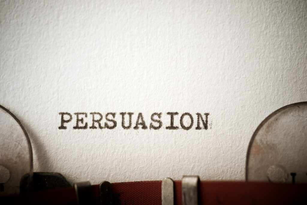 Persuasive writing: A close-up of a typewriter that has written out, “persuasion.”