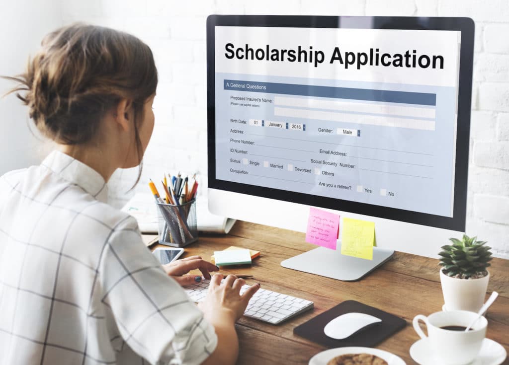 Female student at computer working on scholarship application