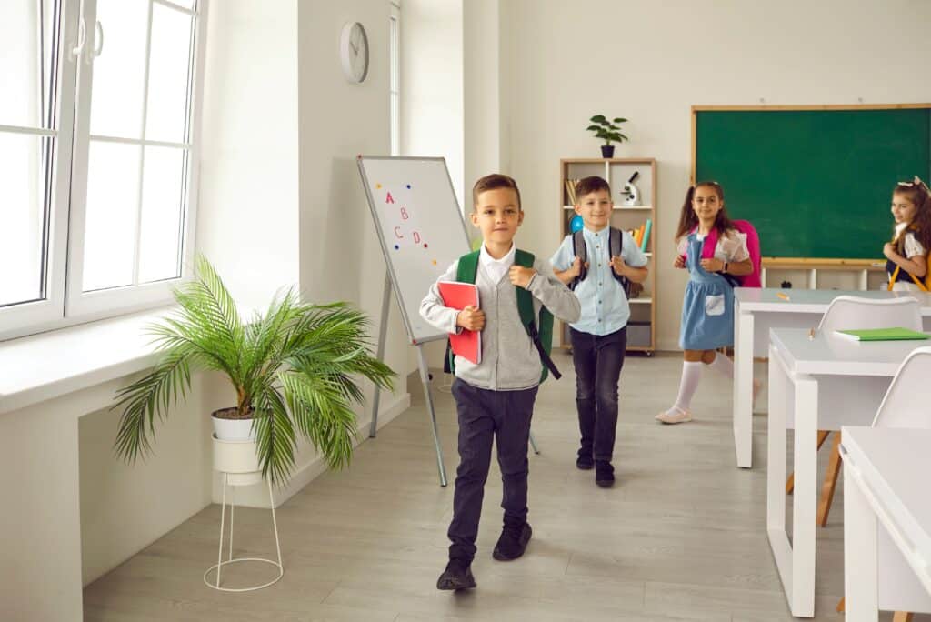 A group of young students leaving class after class is over and they’ve done their exit ticket.