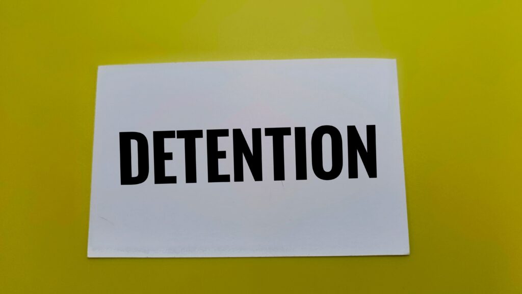 A piece of paper with the word “detention” written on it.