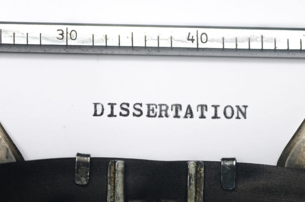 ‘Dissertation’ typed on paper still in a typewriter.