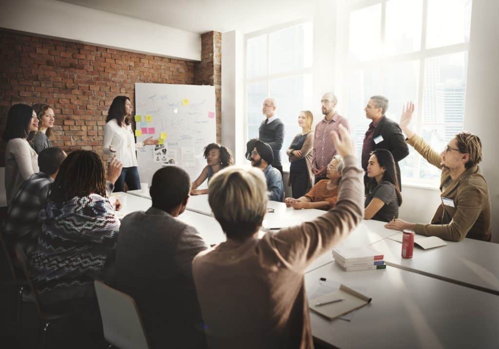 Group of colleagues discussing issues at a conference table.